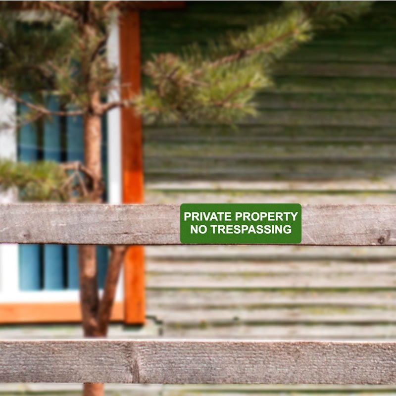 Aluminum Sign Stating PRIVATE PROPERTY NO TRESSPASSING