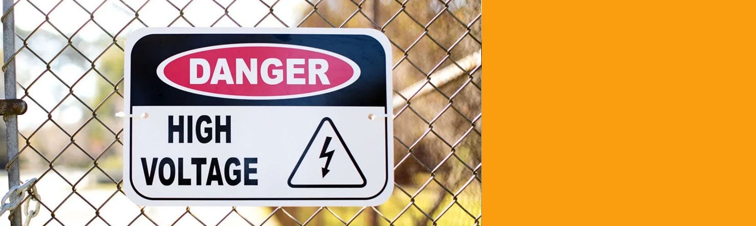 high voltage sign on fence